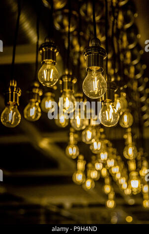 Close up of LED bulbs on long cords handing from the ceiling in Ikea store . Stock Photo