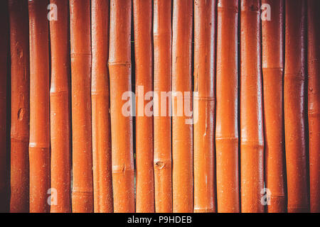 Vintage orange wooden bamboo wall background Stock Photo
