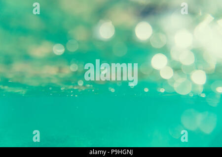 Bokeh light background in the pool. Abstract underwater background with air bubbles in rasfokus. Stock Photo