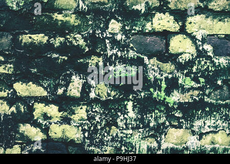 abandoned grunge cracked brick stucco wall background. Old, decayed wall with peeling plaster. Stock Photo