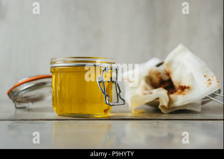 clarified liquid ghee butter in glass jar Stock Photo