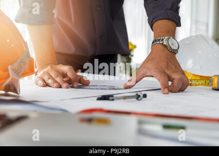 Architect or engineer using pencil and protractor working on blueprint, architectural concept Stock Photo