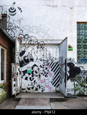 Berlin, Friedrichshain, RAW Gelände. Skatehalle skate boarding hall emergency exit with black & white artwork Stock Photo