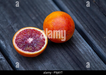 Cut juicy blood orange on wood. Stock Photo