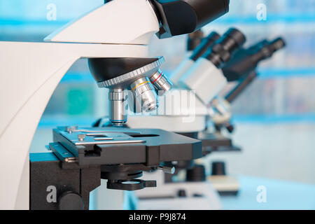 Four microscopes of different designs in the laboratory Stock Photo