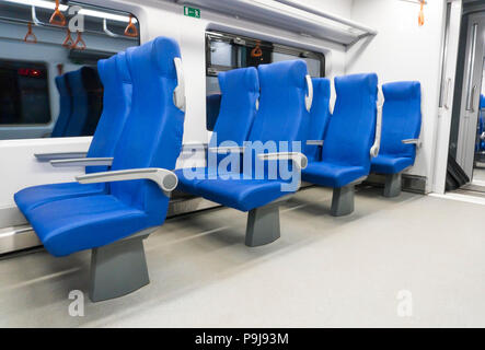 Blue armchairs in the modern speed train Stock Photo