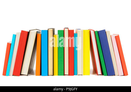 Long row of colorful library books isolated on white background . Stock Photo