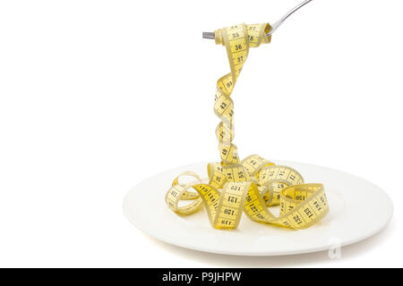 Diet concept, measuring tape looks like pasta put on fork, on white background, losing weight Stock Photo