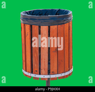 Wooden garbage can for rubbish isolated on green background Stock Photo