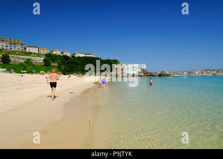 Man jogging along Porthminster Beach at St Ives in Cornwall Stock Photo