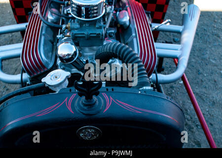 hot rod in red and black in an old ghost town with chrome and red custom paint job on the engine with a black hood ornament Stock Photo