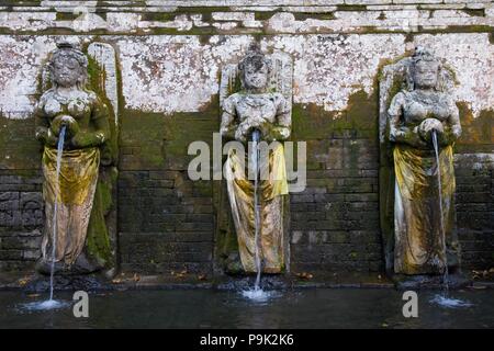 Traditional Balinese sculpture in front of a water pool, inside Goa Gajah tourism spot. Located near Ubud, Bali, Indonesia. Stock Photo