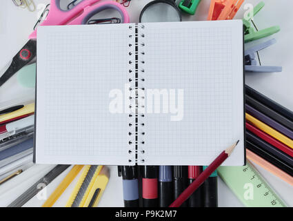 opened Notepad on office supplies on white background Stock Photo