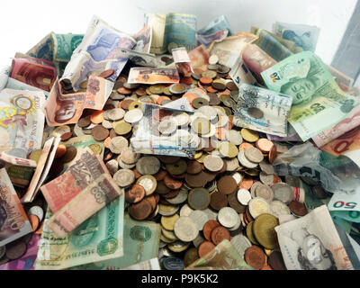 Large plastic secure money box collecting foreign currency from generous passengers donating as they pass through Manchesters International Airport Stock Photo