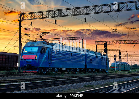 trains and wagons, railroad infrastructure, beautiful sunset and colorful sky, transportation and industrial concept Stock Photo