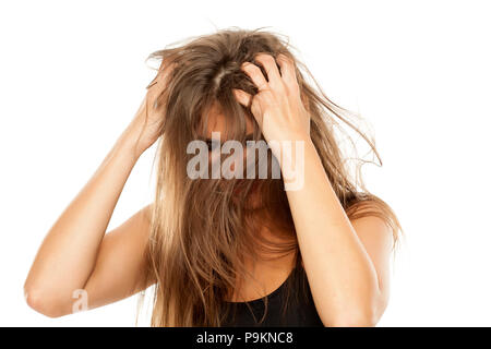 young beautiful woman has itching in her hair Stock Photo