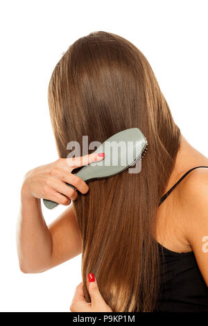 young woman combing her beautiful long hair Stock Photo