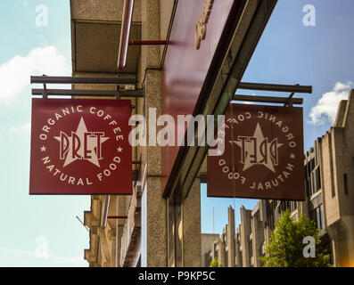 Sign above the doorway to a branch of the Pret a Manager sandwich shop chain in central London. The sign is reflected in the window of the shop. Stock Photo