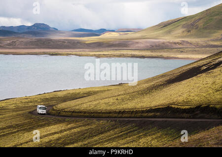 Bus drives on a dirt road near Frostastadavatn Lake in Landmannalaugar (Rainbow Mountains), Iceland Stock Photo