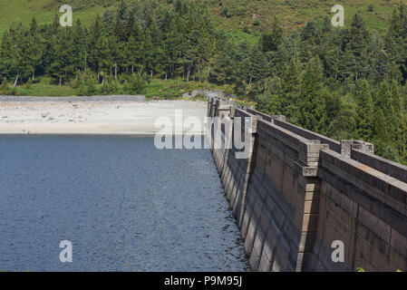 Haweswater, Cumbria UK. 19th July, 2018. The low water level at the dam of Haweswater Reservoir that was filled in the 1930's to aid drinking water to be pumped to Manchester over 80-miles away. Pic taken 19/07/2018. Credit: Stop Press Media/Alamy Live News Stock Photo