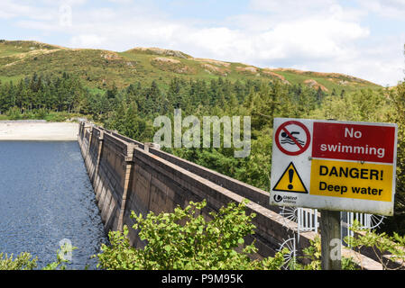 Haweswater, Cumbria UK. 19th July, 2018. The low water level at the dam of Haweswater Reservoir that was filled in the 1930's to aid drinking water to be pumped to Manchester over 80-miles away. Pic taken 19/07/2018. Credit: Stop Press Media/Alamy Live News Stock Photo