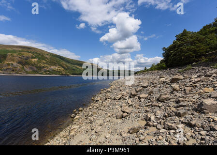 Haweswater, Cumbria UK. 19th July, 2018. The low water level at the dam of Haweswater Reservoir that was filled in the 1930's to aid drinking water to be pumped to Manchester over 80-miles away. Pic taken 19/07/2018. Credit: Stop Press Media/Alamy Live News Stock Photo