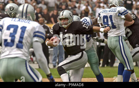 Jan 19, 2002; Foxboro, MA, USA; Oakland Raiders quarterback Rich Gannon,  #12, holds his head in dejection after teammate Jerry Rice, #80, drops a  pass in the 4th qt. during their AFC