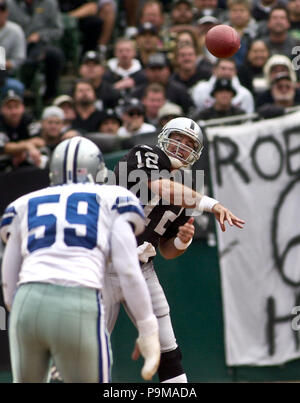 Jan 19, 2002; Foxboro, MA, USA; Oakland Raiders quarterback Rich Gannon,  #12, holds his head in dejection after teammate Jerry Rice, #80, drops a  pass in the 4th qt. during their AFC