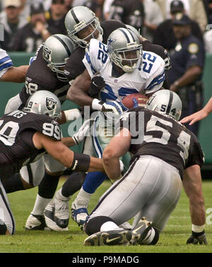 Dallas Cowboys' running back Emmitt Smith adjusts his mouth guard as he  checks the replay from the bench, in the second quarter against the Green  Bay Packers during their NFC playoff game