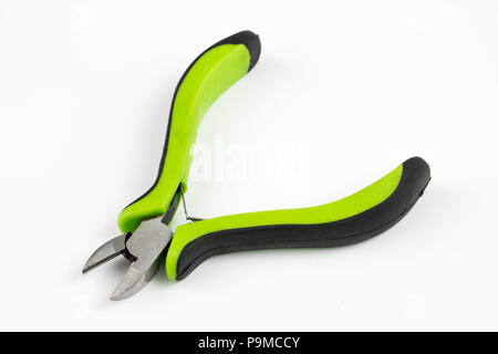Pliers and cable cutters on a white table. Accessories for DIY enthusiasts and electricians. White background. Stock Photo