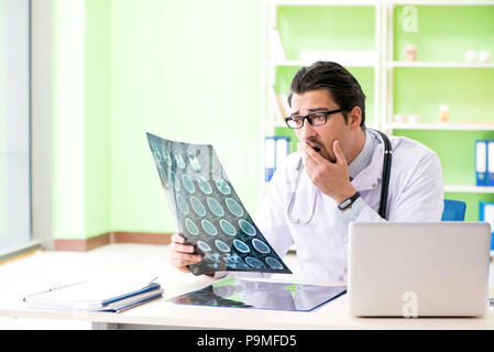 Doctor radiologist looking at x-ray scan in hospital Stock Photo