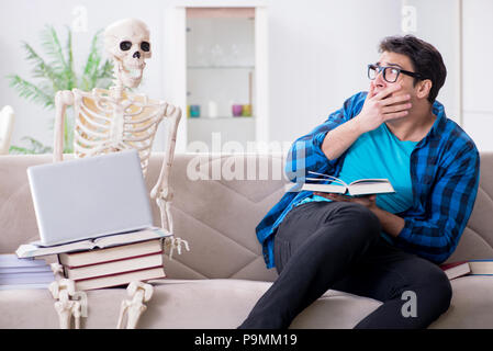 Student studying with skeleton preparing for exams Stock Photo