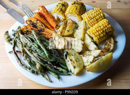 Baked vegetables - green beans, carrots, corn and potatoes - Vegetarian menu Stock Photo