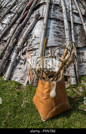 native american lodges and birchbark canoe in a canadian