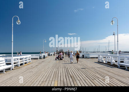 Sopot, Poland - July 27, 2018: Tourists walking on wooden Sopot Pier in a sunny day. It is the longest wooden pier in Europe and is located on the coa Stock Photo