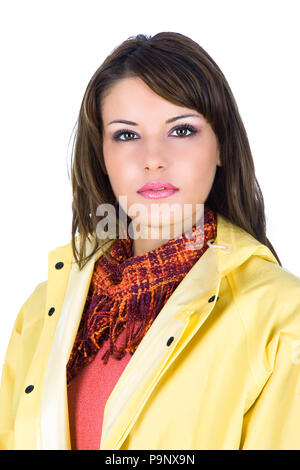 Beautiful young woman wearing a yellow rain-coat, studio shot Stock Photo