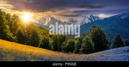 day and night composite of mountainous landscape. time change concept. perfect countryside scenery with beech forest on a grassy hillside and High Tat Stock Photo