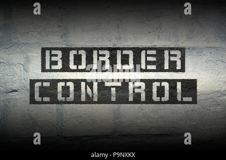 border control stencil print on the grunge white brick wall Stock Photo