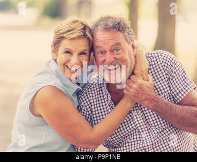 Happy smiling senior couple in love, relaxing, dancing and having fun in the park. Being together strong, retirement happy life concept. Stock Photo