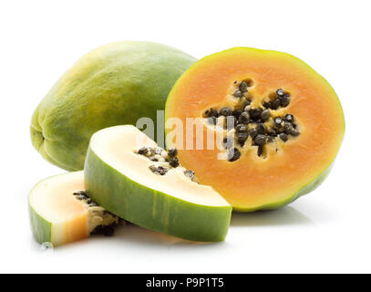 Green papaya (pawpaw, papaw) one whole one half and two slices with seeds isolated on white background Stock Photo