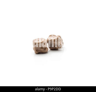 Two coconut cubes in milk chocolate isolated on white background Stock Photo