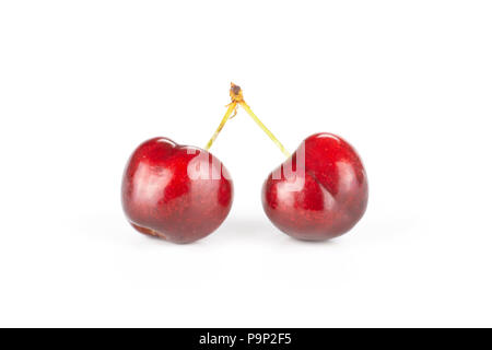 Group of two whole sweet bright red cherry joined stem isolated on white Stock Photo