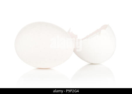 One white chicken egg and cracked eggshell half piece isolated on white background Stock Photo