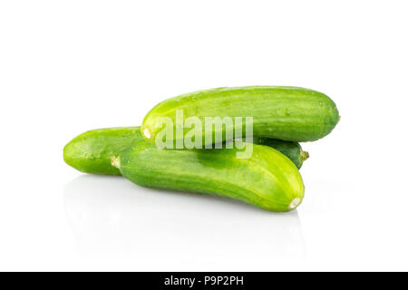 Three fresh green mini cucumbers stack isolated on white background Stock Photo