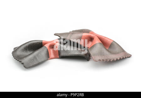 Farfalle pasta with black cuttlefish ink isolated on white background two raw classic traditional Italian Stock Photo