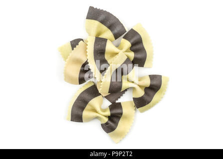 Farfalle pasta with black cuttlefish ink isolated on white background top view raw classic traditional Italian five pieces stack Stock Photo