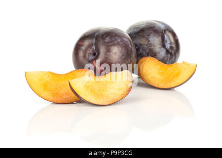 Two red blue plums and three slices isolated on white background Stock Photo