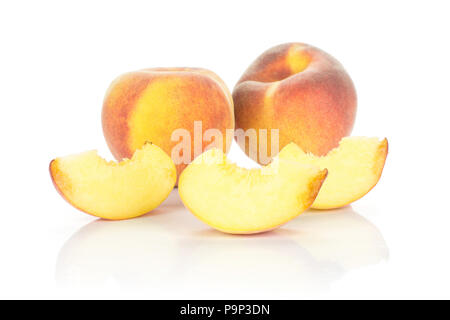 Two yellow peaches and three slices isolated on white background Stock Photo