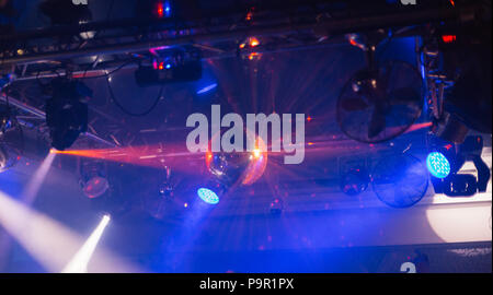 Mirror ball in a nightclub with different lights. Stock Photo