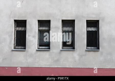 Three modern window frames on a blank grungy brown concrete wall under Stock Photo